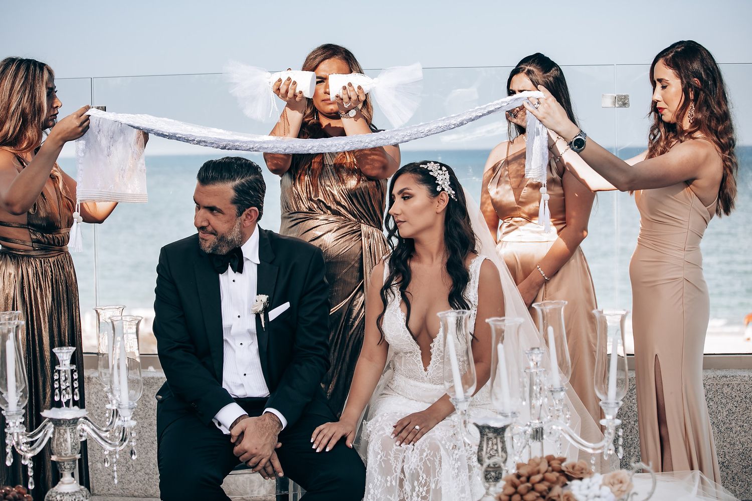 Wedding celebration with guests in formal attire dancing and celebrating at an elegant venue.