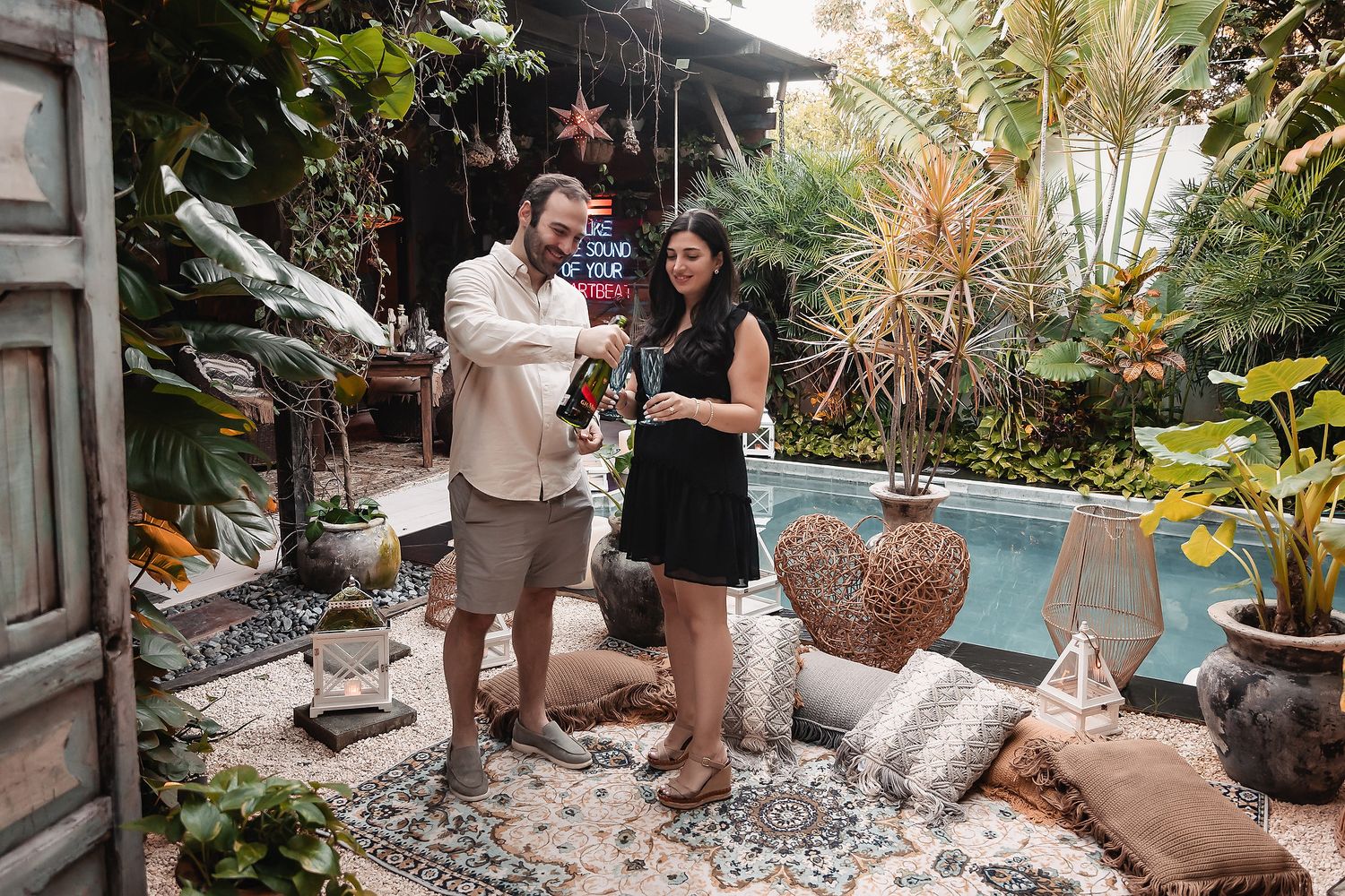 Garden photo session setup with photographers and equipment among tropical plants.