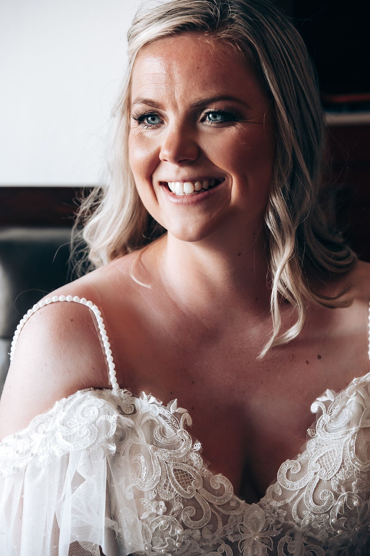 Sequence of bridal portraits showing delicate white lace details on an off-shoulder wedding gown.