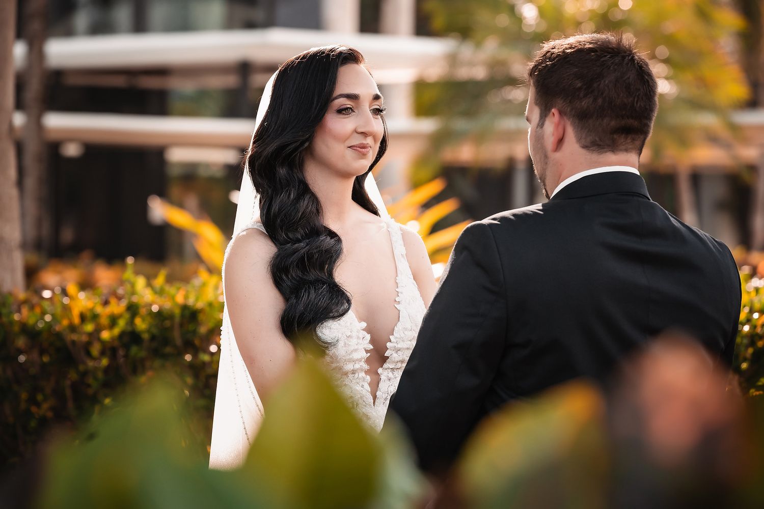 A couple shares an intimate moment during their autumn wedding photoshoot with golden foliage in the background.