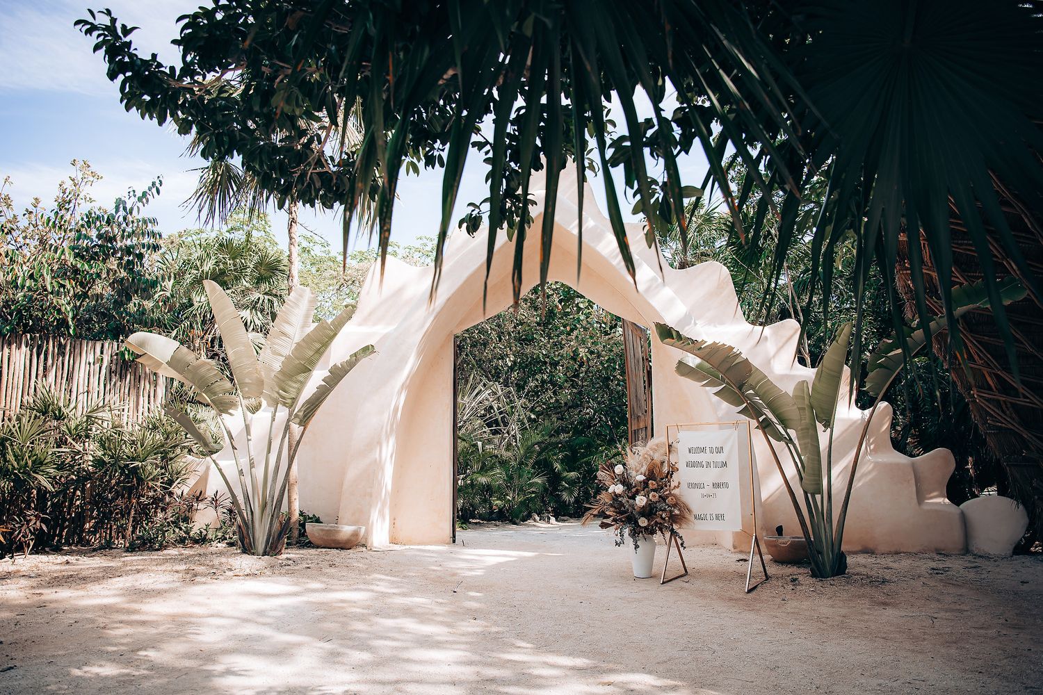 A series of connected photos showing a peaceful desert garden with adobe walls, palm trees and natural landscaping.