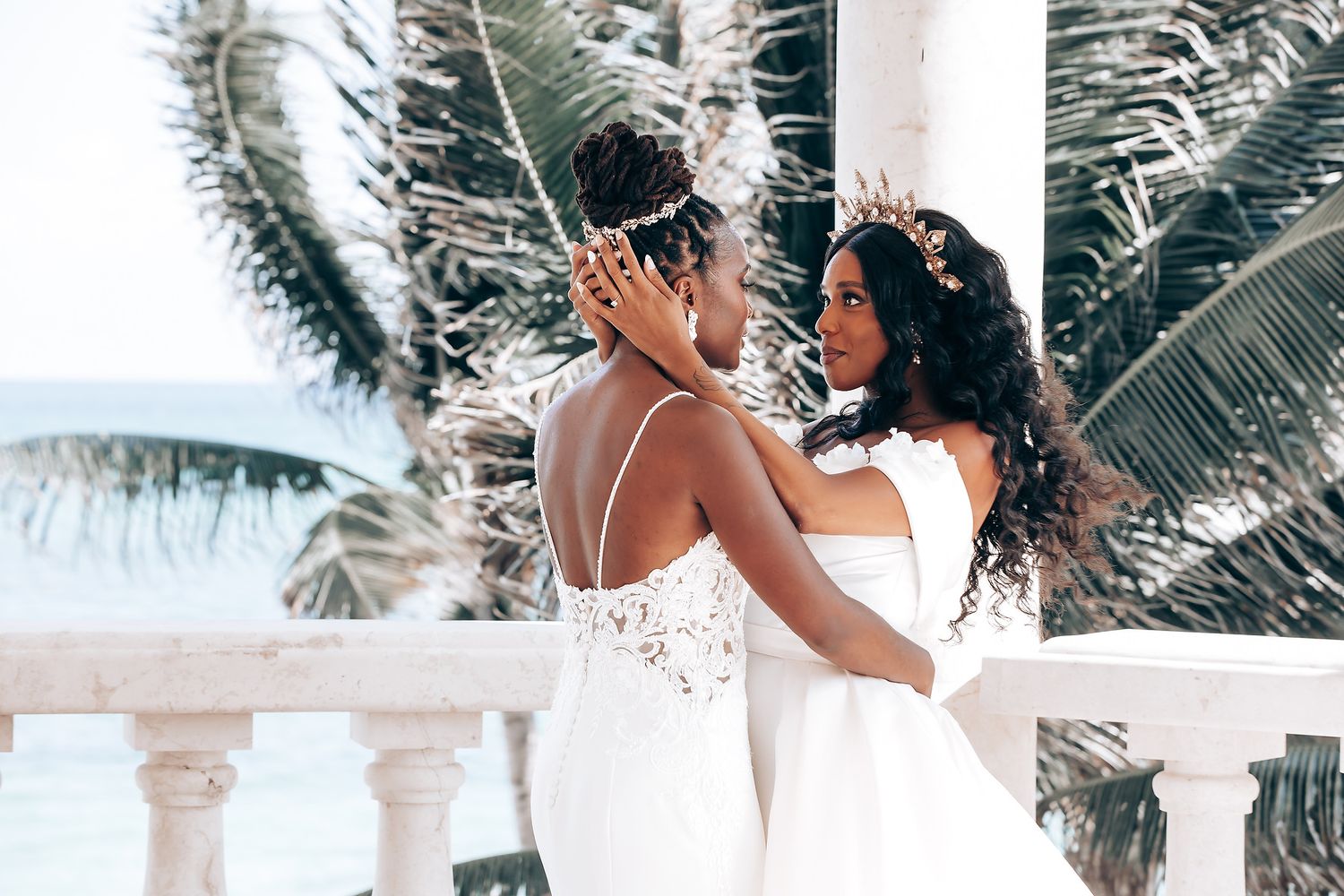 A beautiful beachfront wedding venue with white columns and tropical landscaping.