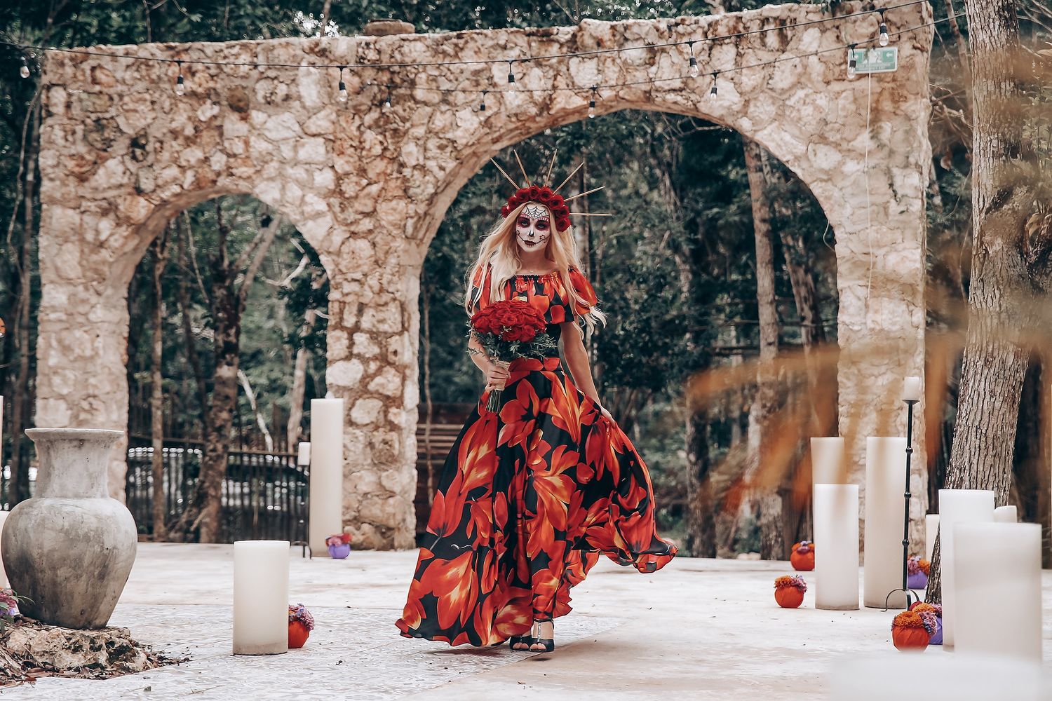 Red-cloaked figures move through stone archways in a snow-covered courtyard.