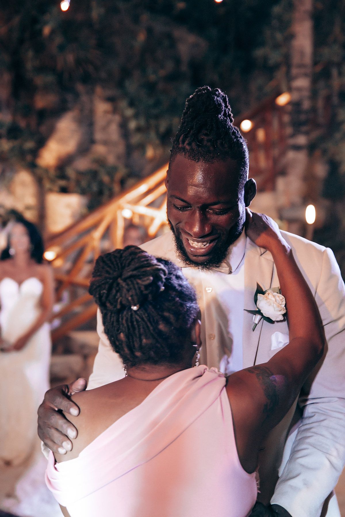 Emotional reception moments captured during a candlelit evening celebration.