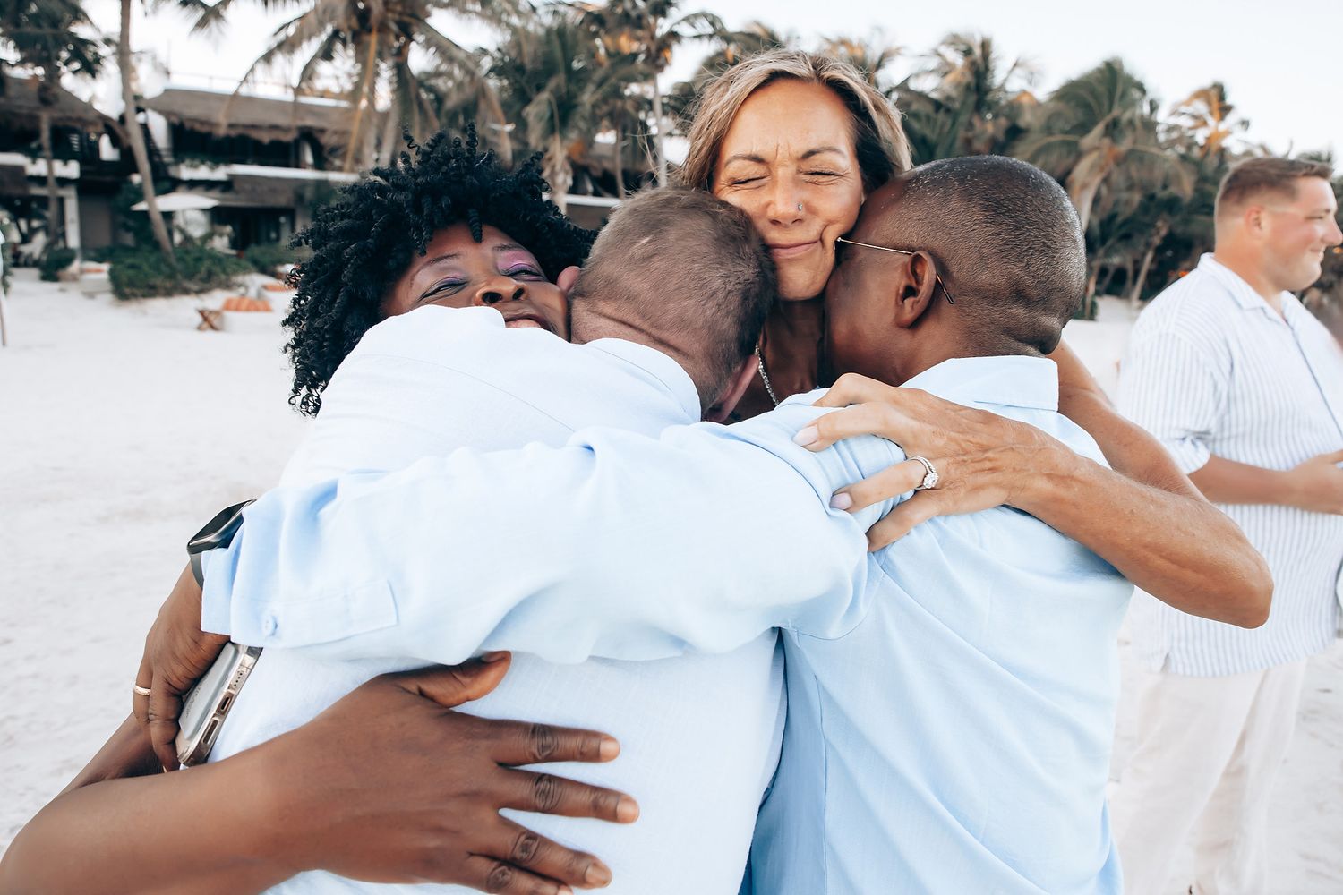 A group of people embrace in a joyful celebration.