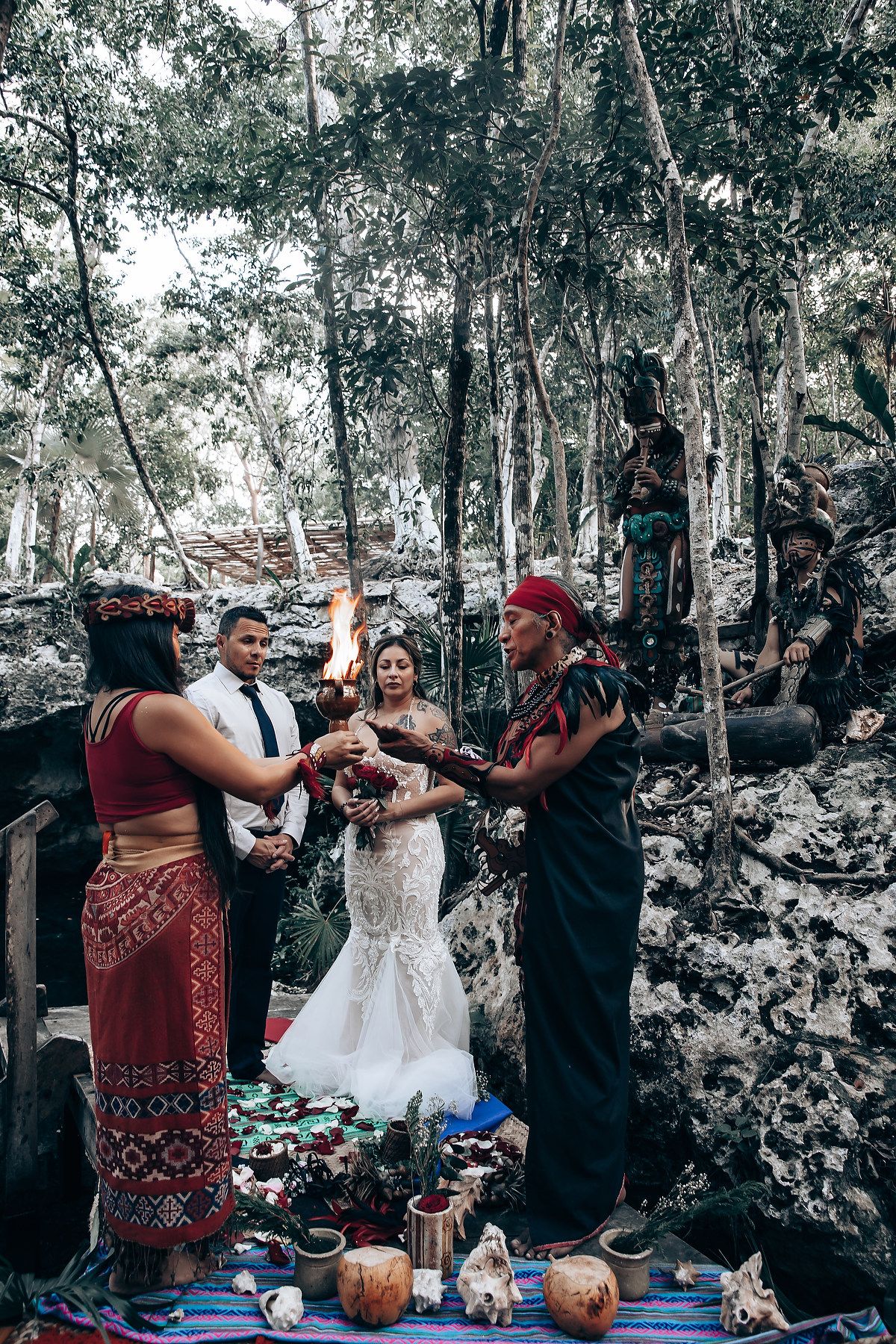 A unique wedding ritual taking place in a forest clearing with decorative elements and props.