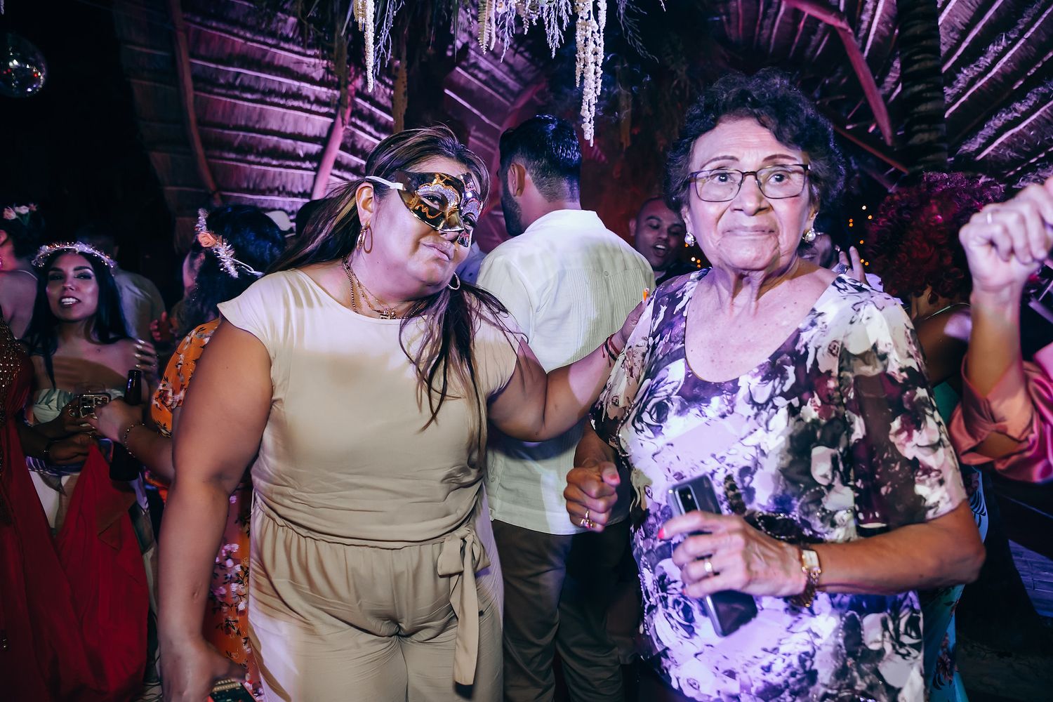 Party guests dancing and enjoying themselves at a nighttime celebration.