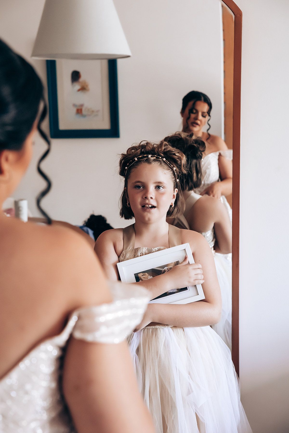 Wedding preparation moments captured in a bright interior setting.