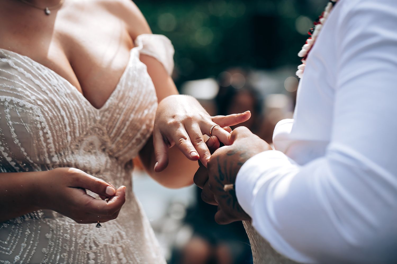 A couple shares an intimate moment during their wedding ceremony with hands clasped together.