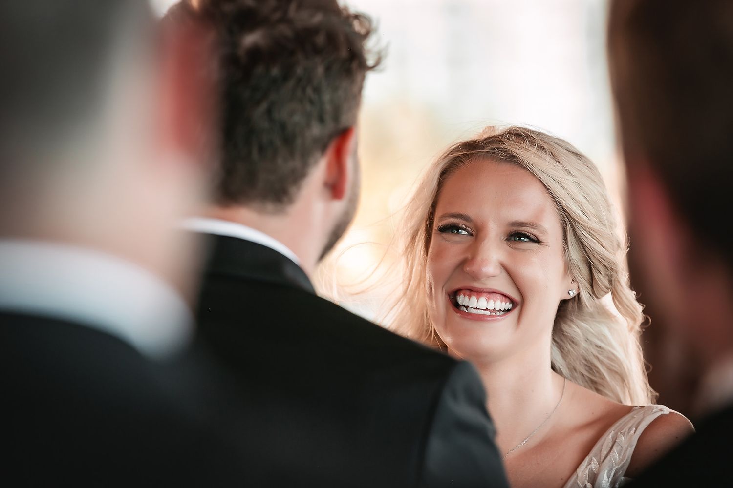 Wedding guests share joyful moments during an elegant indoor celebration.
