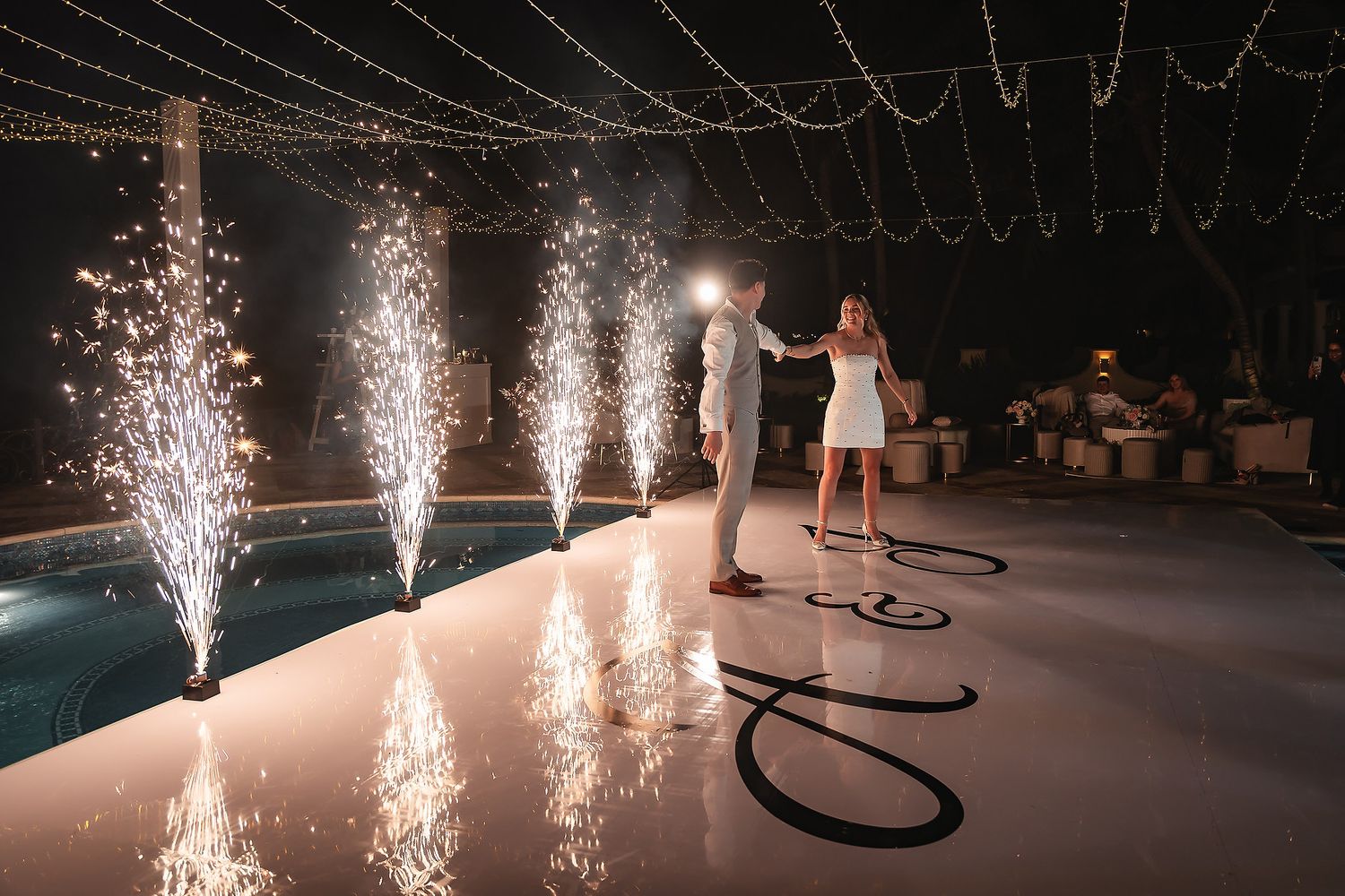 Wedding celebration with line of sparkler fountains creating dramatic light show.