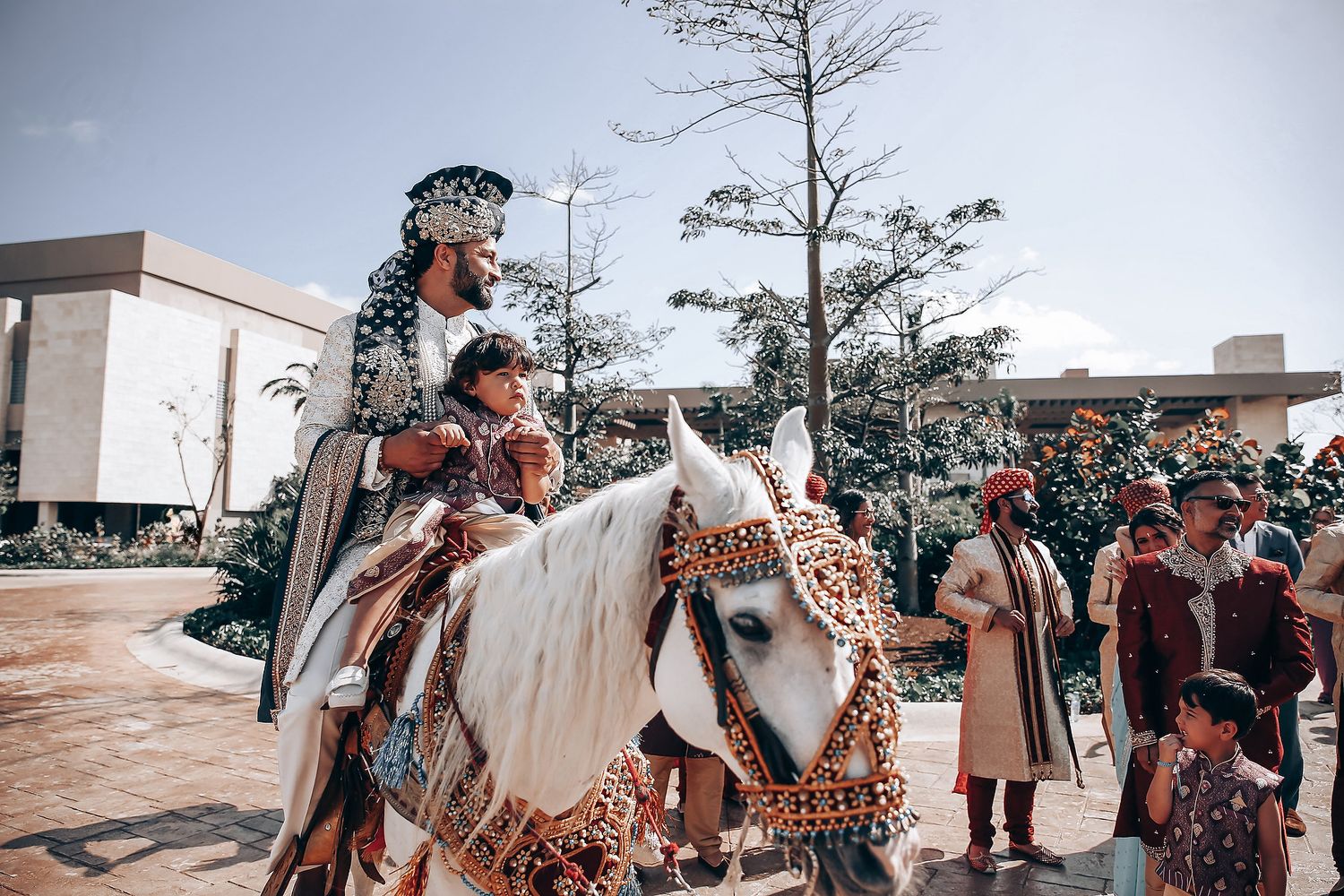 A group of medieval reenactors in period costumes gather at an outdoor historical event.