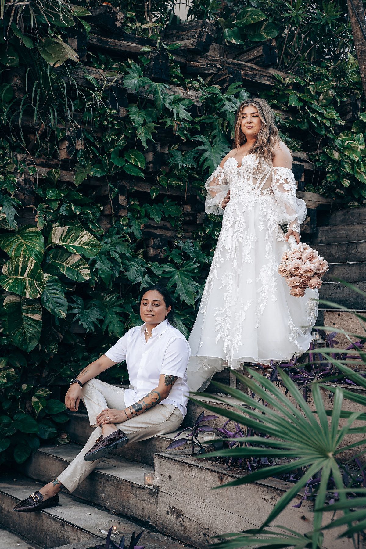 Romantic garden setting with white lace details and tropical greenery backdrop.