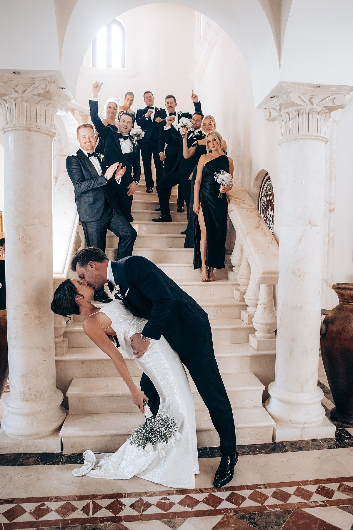 A romantic wedding photoshoot sequence showing a dramatic dip pose in front of elegant white columns.