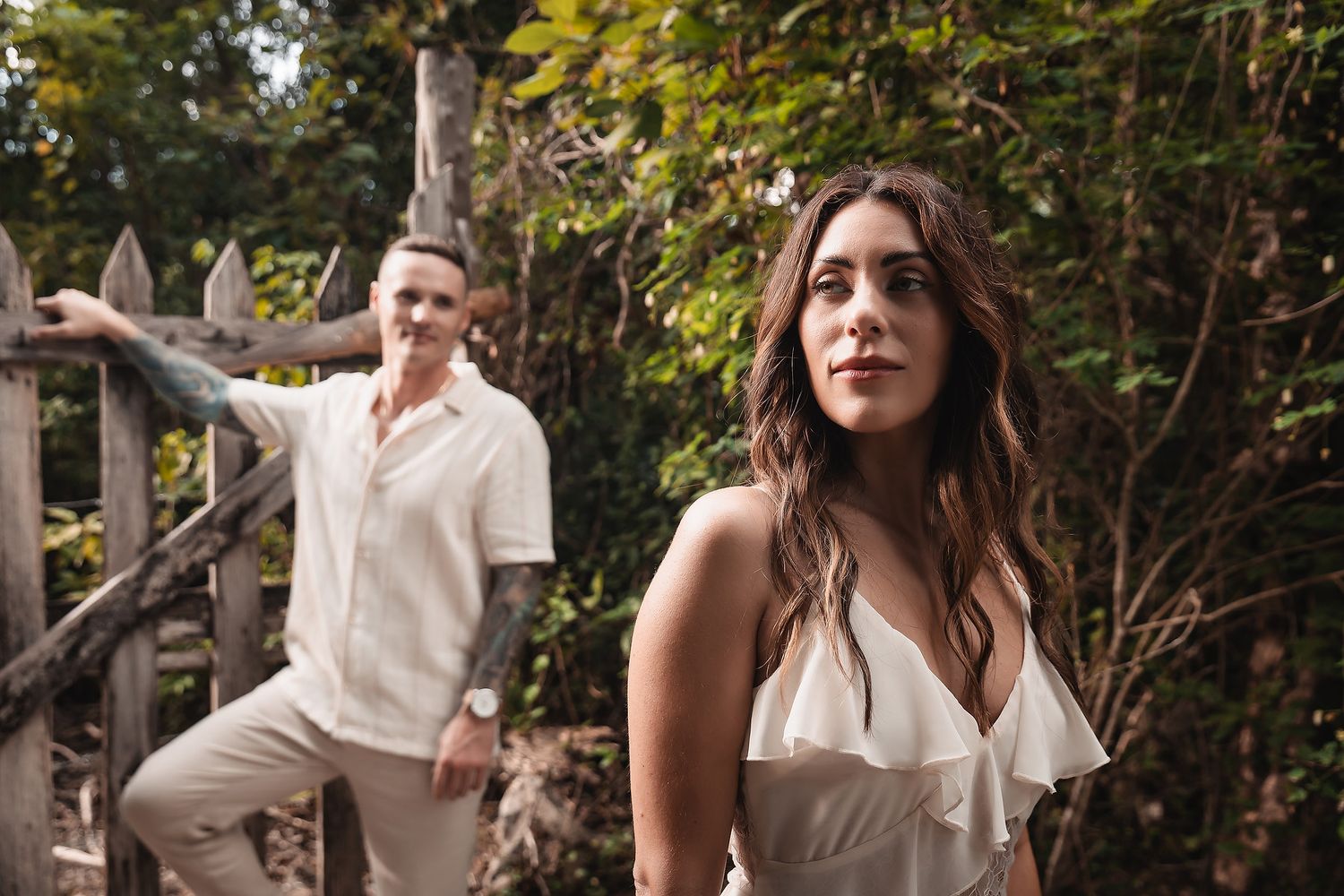 Two people share playful moments together during an outdoor photo session.
