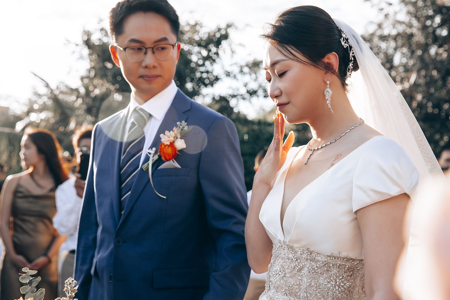 Outdoor wedding ceremony with elegant floral boutonniere and formal attire.