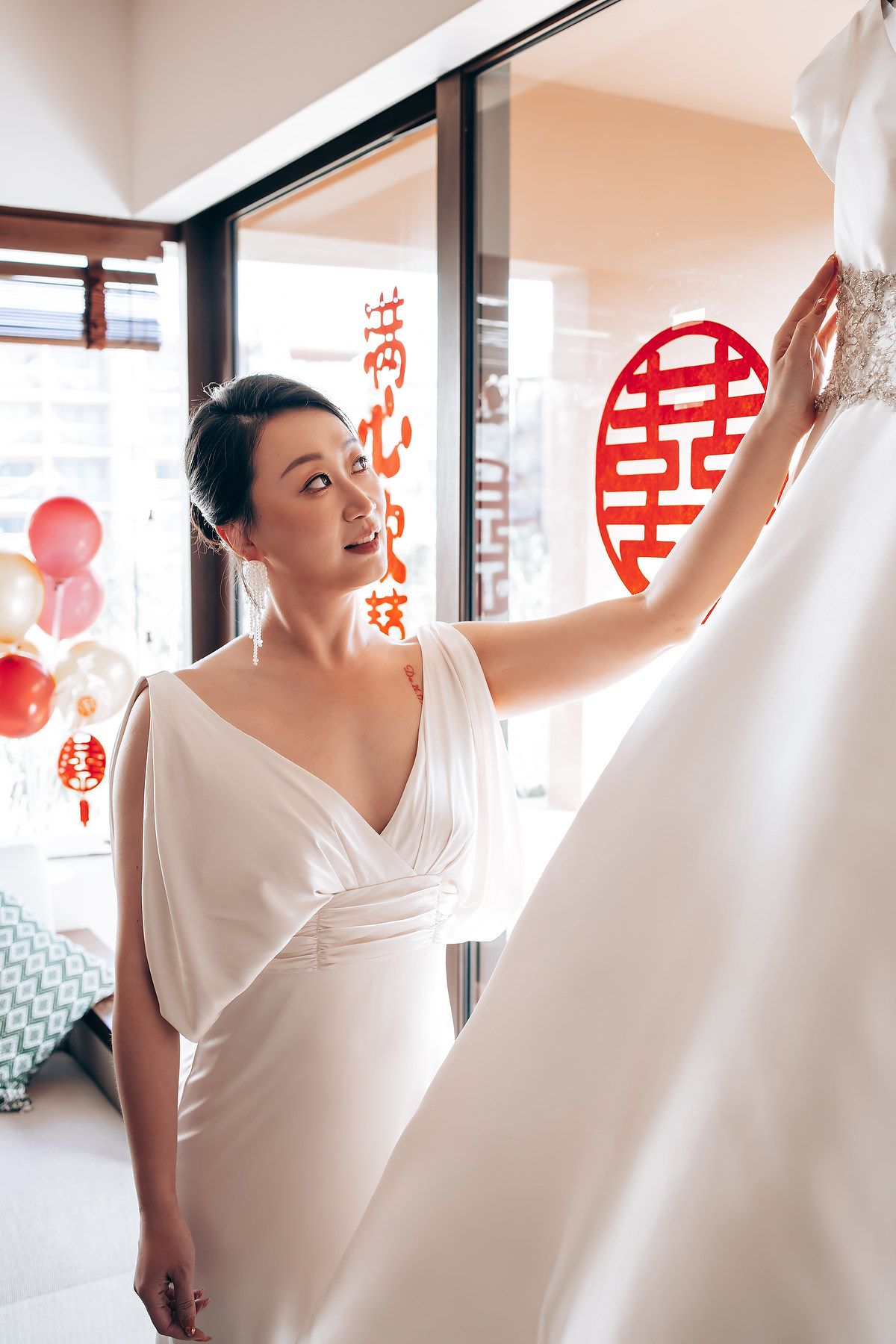 Wedding preparation scene with traditional Chinese double happiness symbols and red decorations.