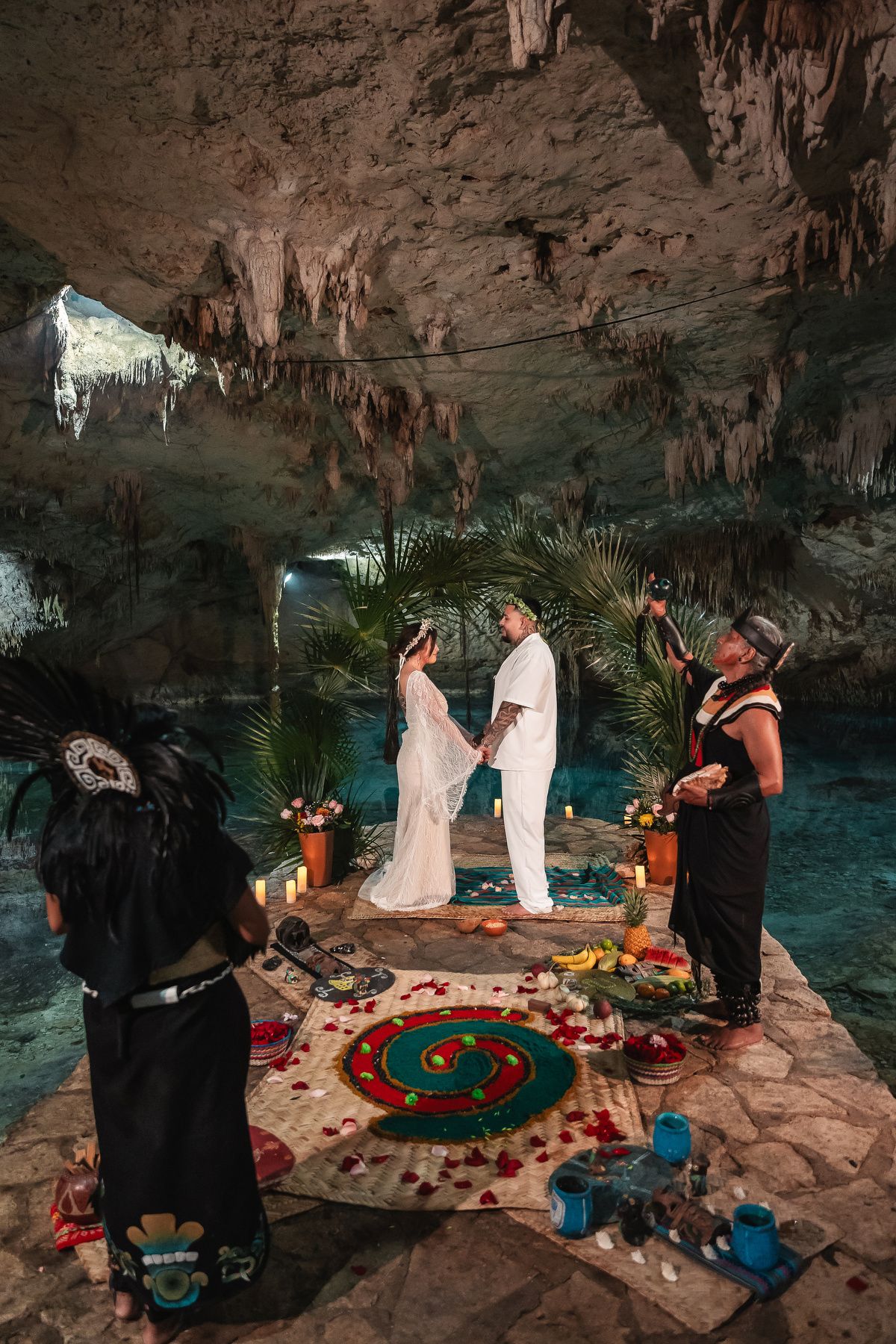 A series of photos showing a wedding ceremony taking place inside a mystical cave with turquoise water and decorative elements.