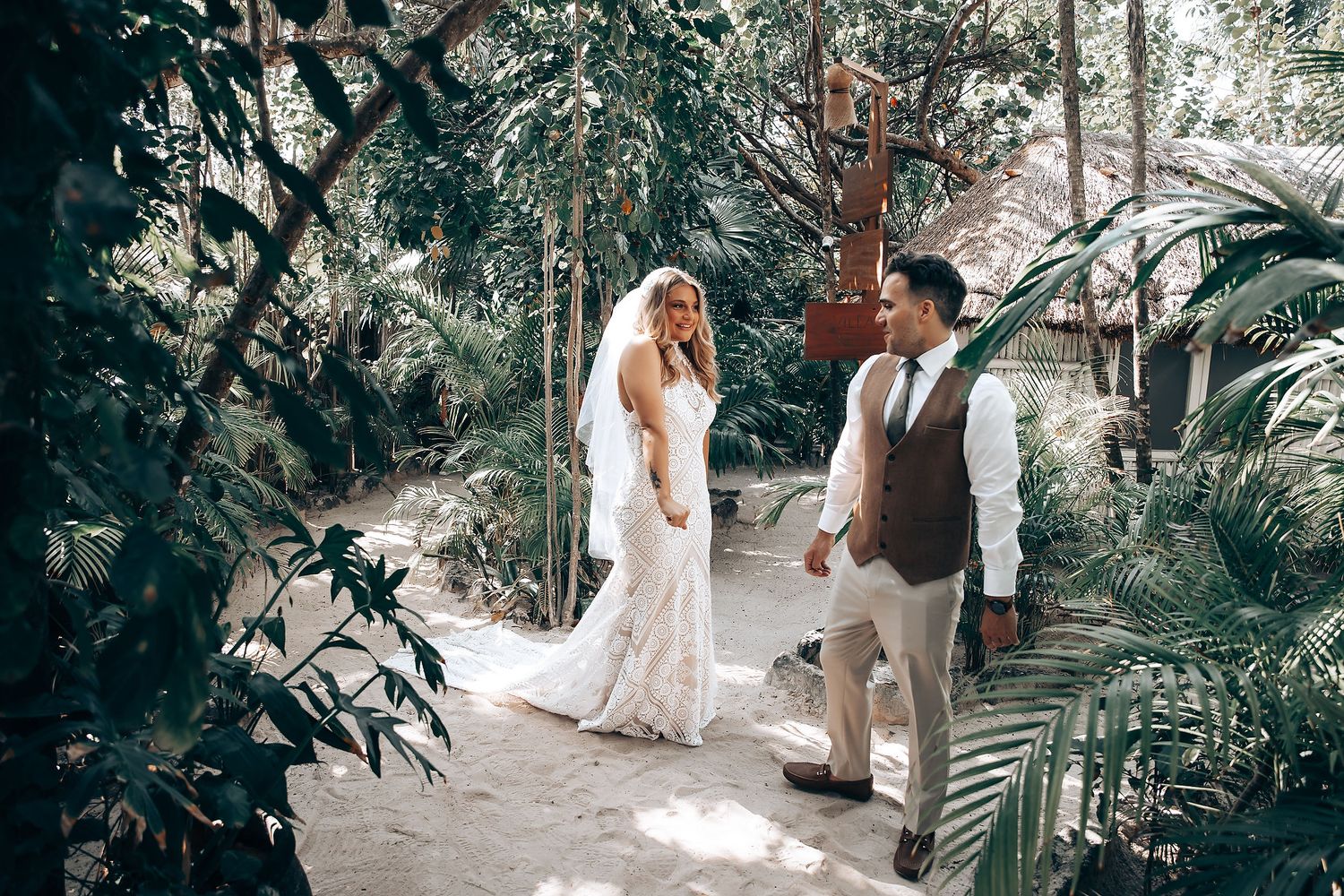 Wedding photography session taking place in a beautiful outdoor garden with tropical foliage.