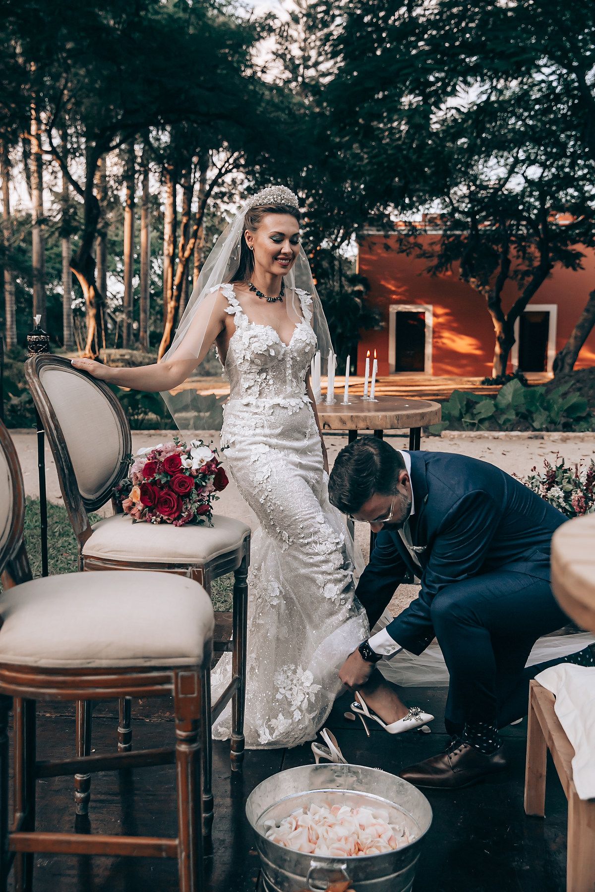 A series of wedding photos showing a bride in a white lace dress posing with vintage furniture in an outdoor setting.