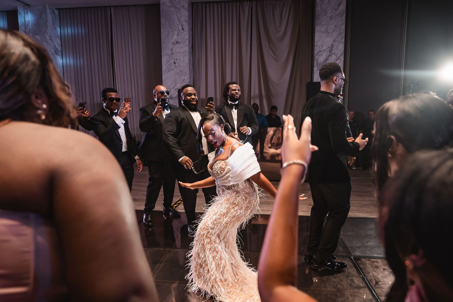 Wedding reception dance party with guests celebrating on a crowded dance floor.