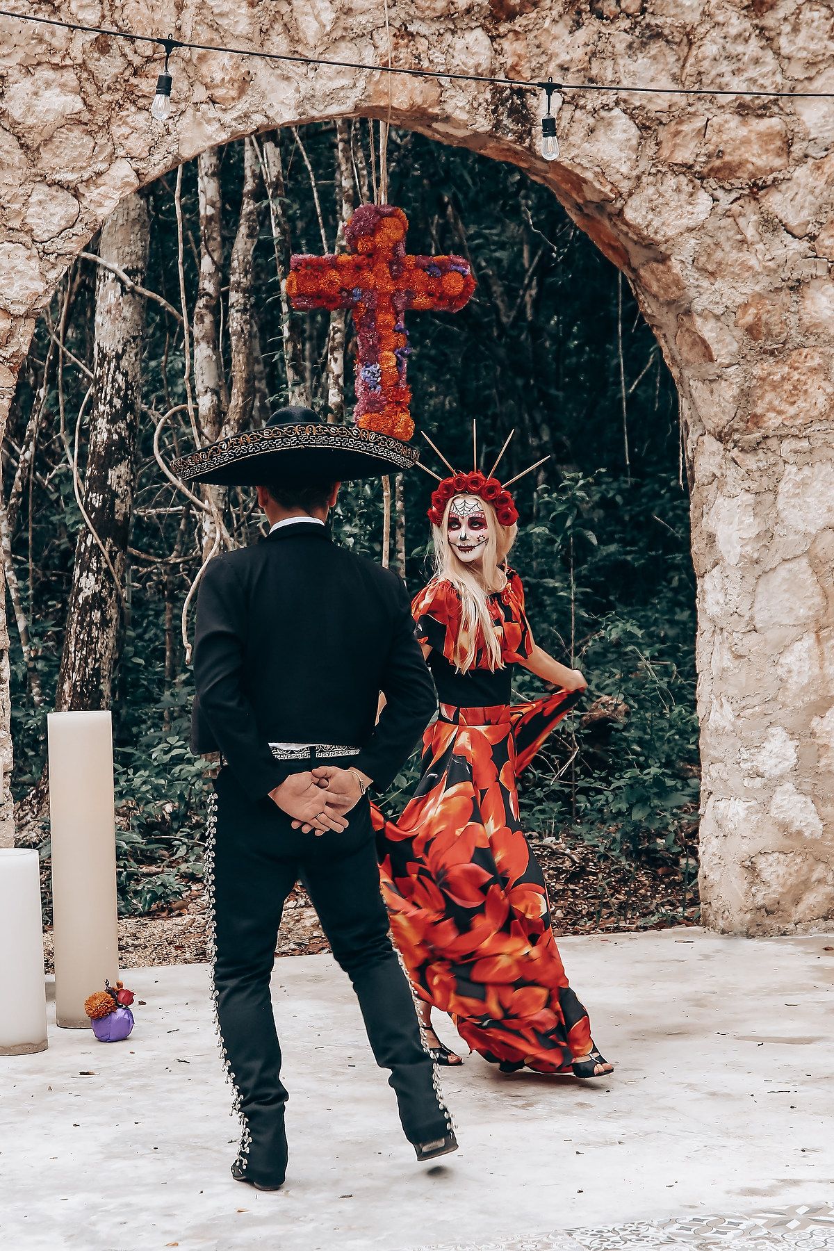 Artistic dance performance featuring red dress twirls against stone ruins in forest setting.