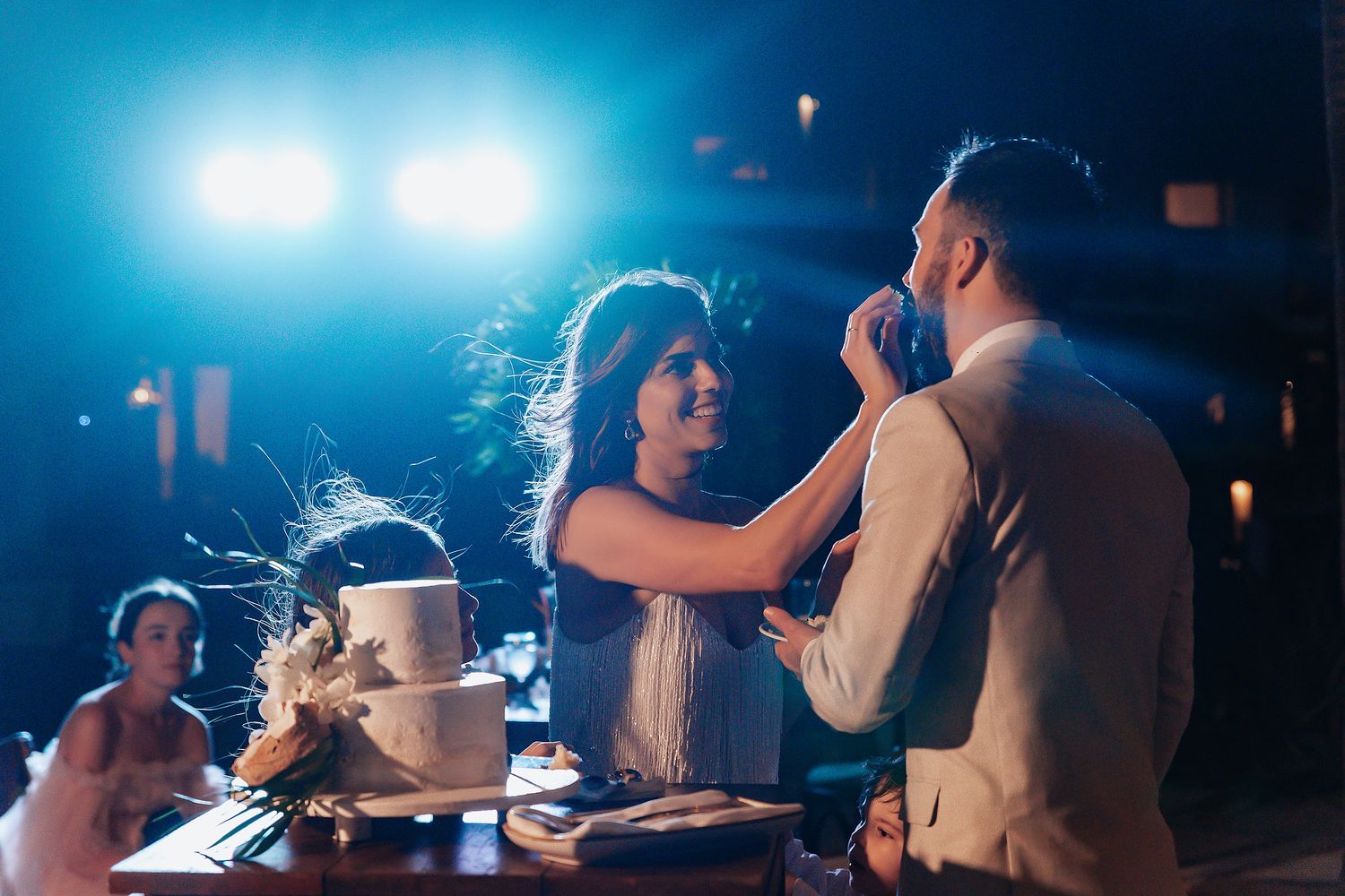 Evening wedding reception with string lights creating a romantic atmosphere on the dance floor.
