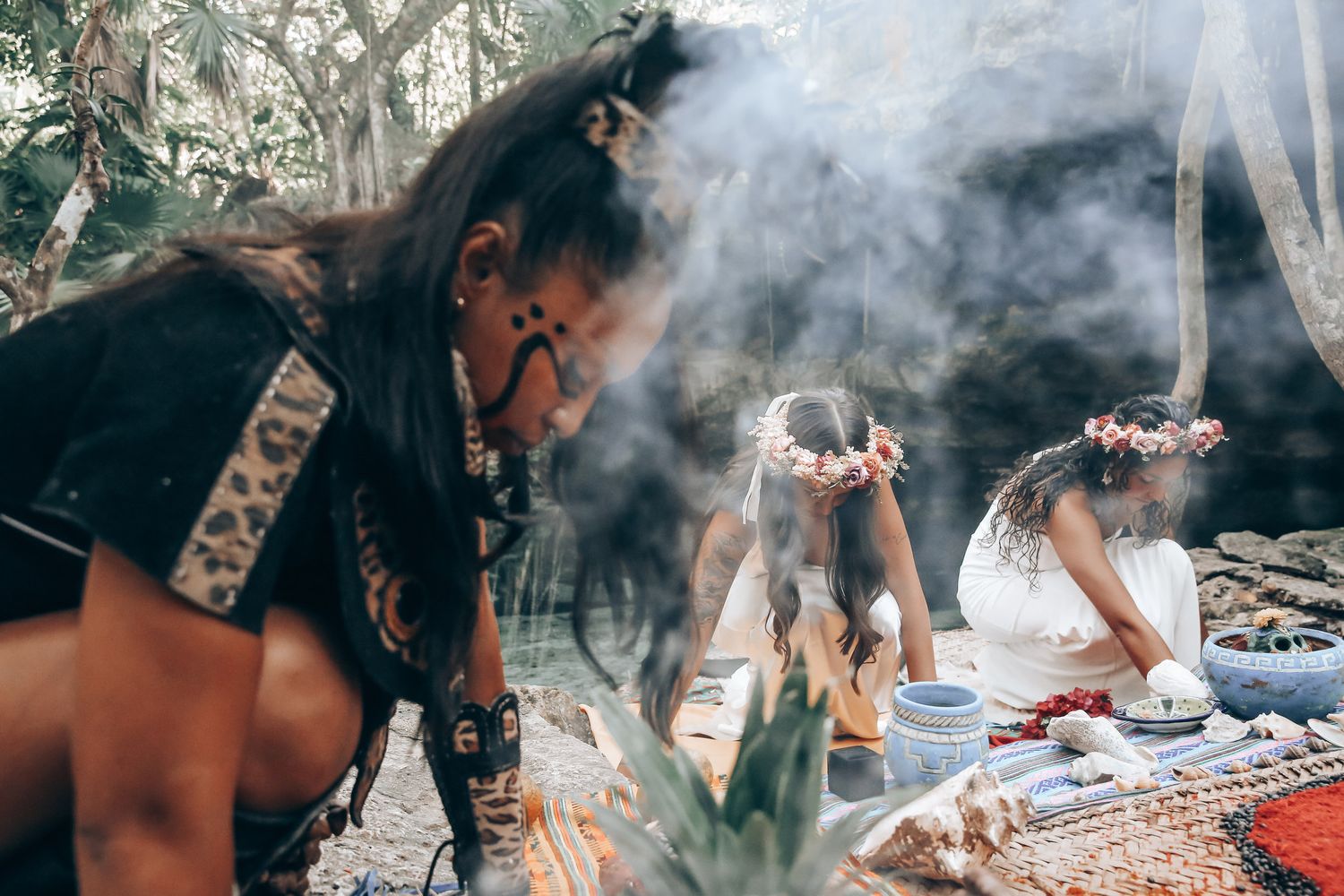 Traditional ceremonial smoke ritual being performed outdoors with decorative elements.