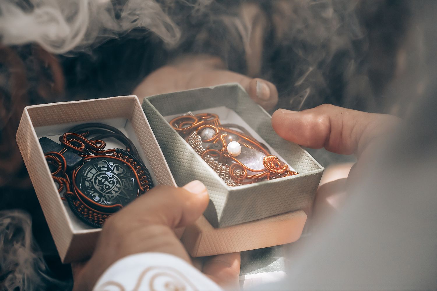 Wedding rings being presented in decorative boxes during ceremony.