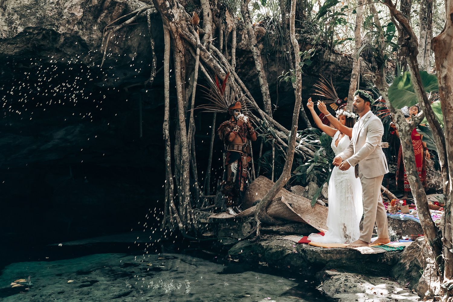 An intimate forest ceremony with bohemian decorations and natural sunlight filtering through the trees.