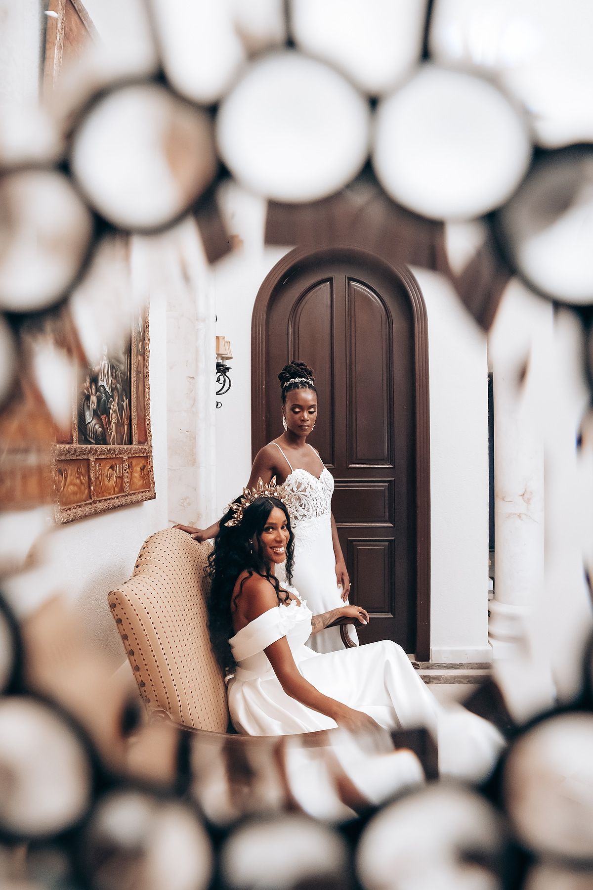 Wedding photography session through decorative arches and doorways in a light-filled space.