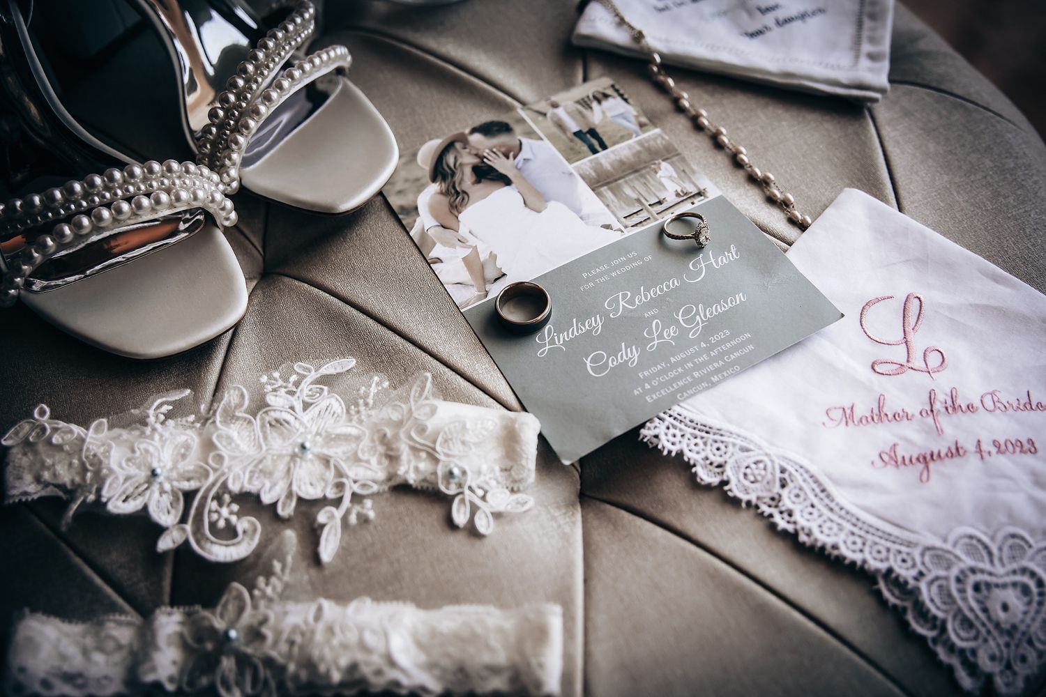 An image depicting various wedding accessories such as a lace veil, jewelry, and a handwritten note on a table.