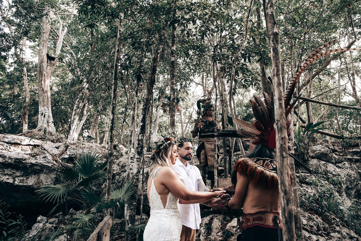 Sunlight streams through eucalyptus trees during outdoor forest ceremony.