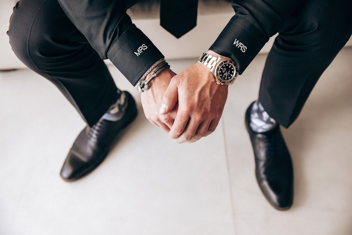Detail shot of formal black dress shoes and suit pants.