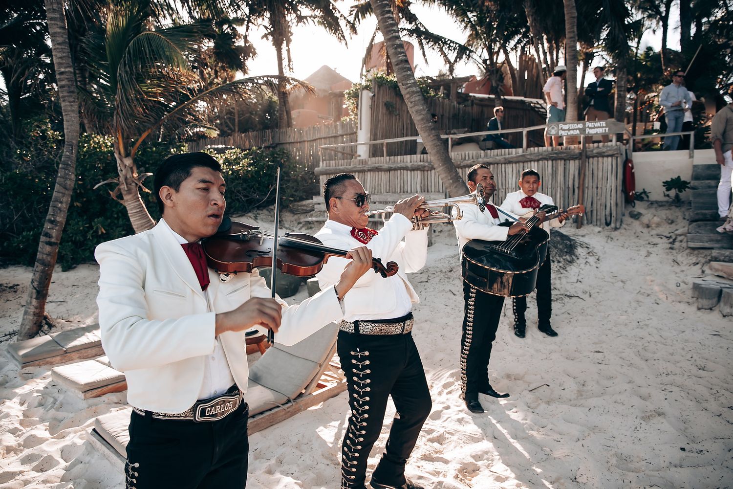 Live band performs traditional music at a beachfront wedding reception.