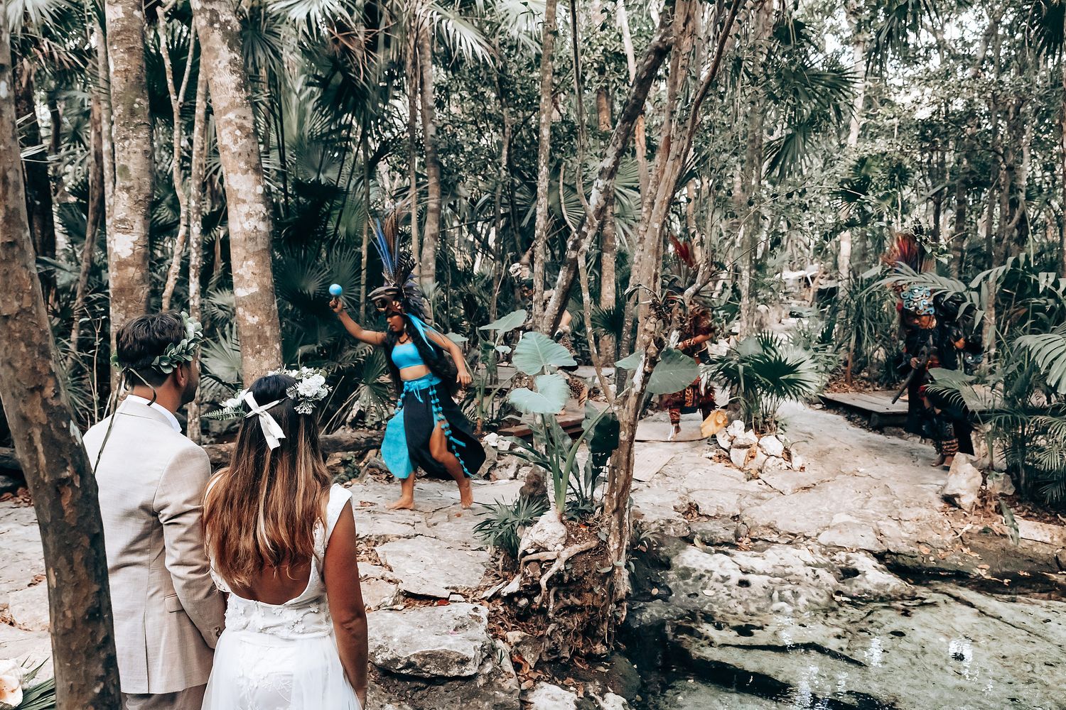 Spiritual ceremony participants gathered in tropical forest setting.