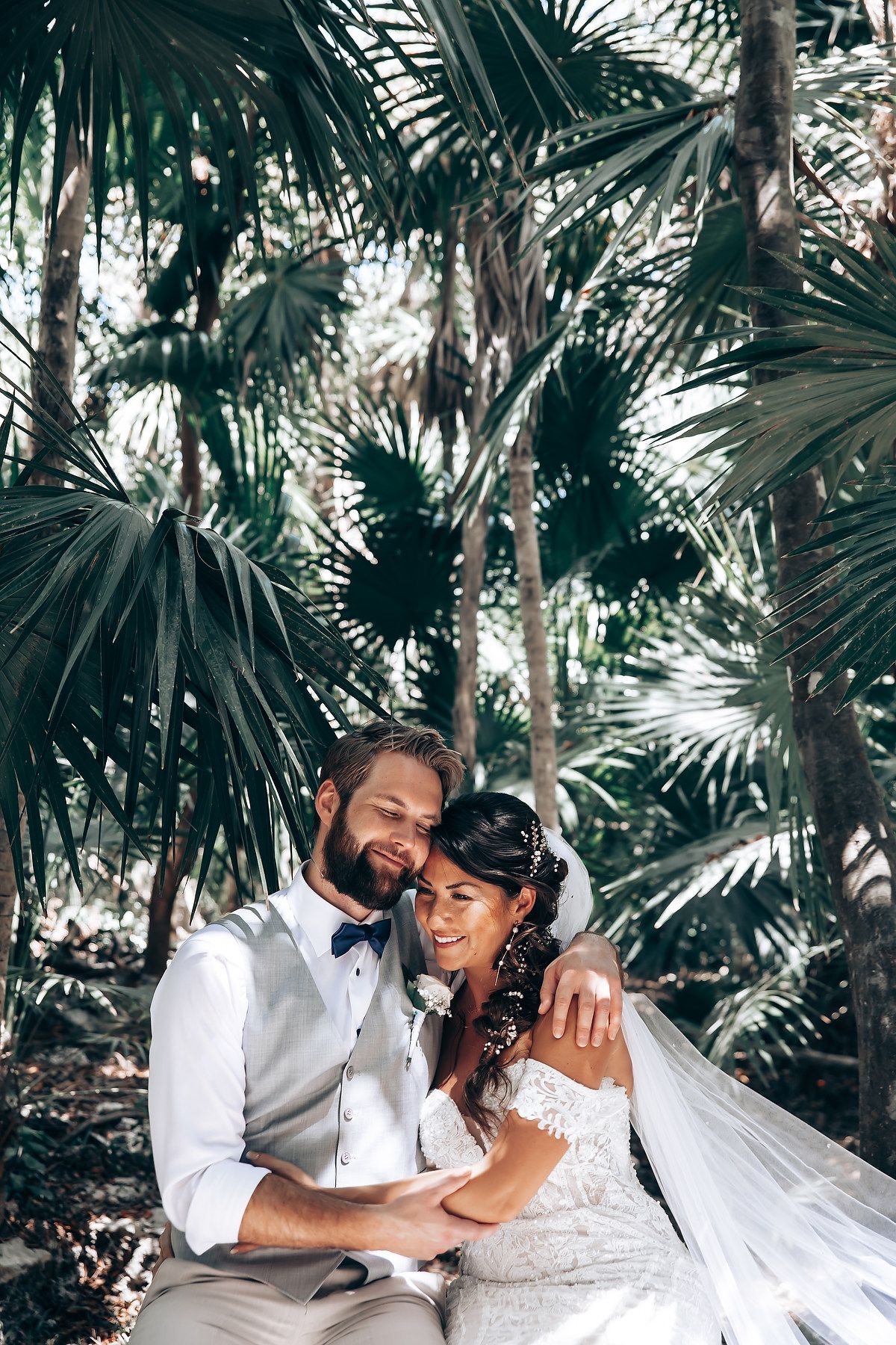 Romantic wedding photoshoot in a tropical palm garden setting.