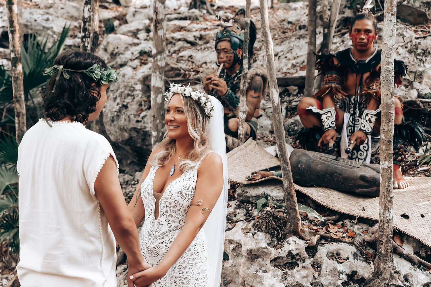 Couple walking hand in hand through a tropical forest setting during a romantic outdoor photoshoot.