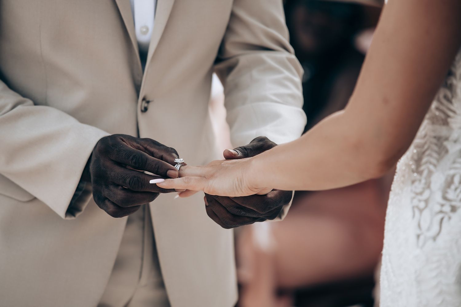 Close-up of wedding couple's tender interaction during ceremony.