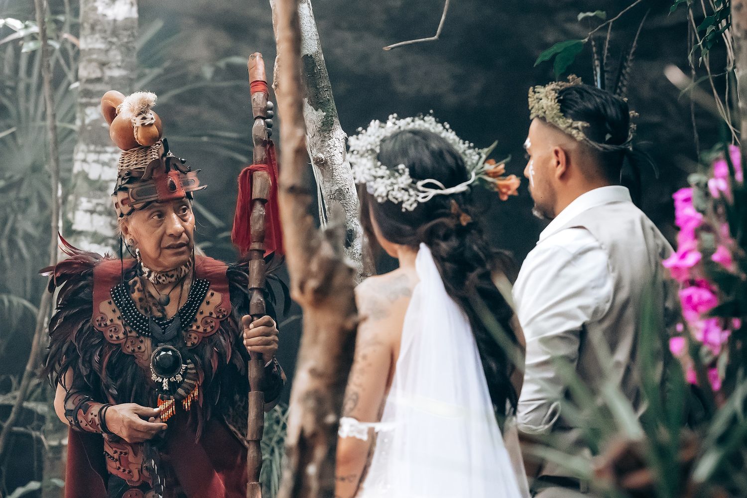 Couple sharing an intimate moment during a wedding ceremony with guests watching in the background.