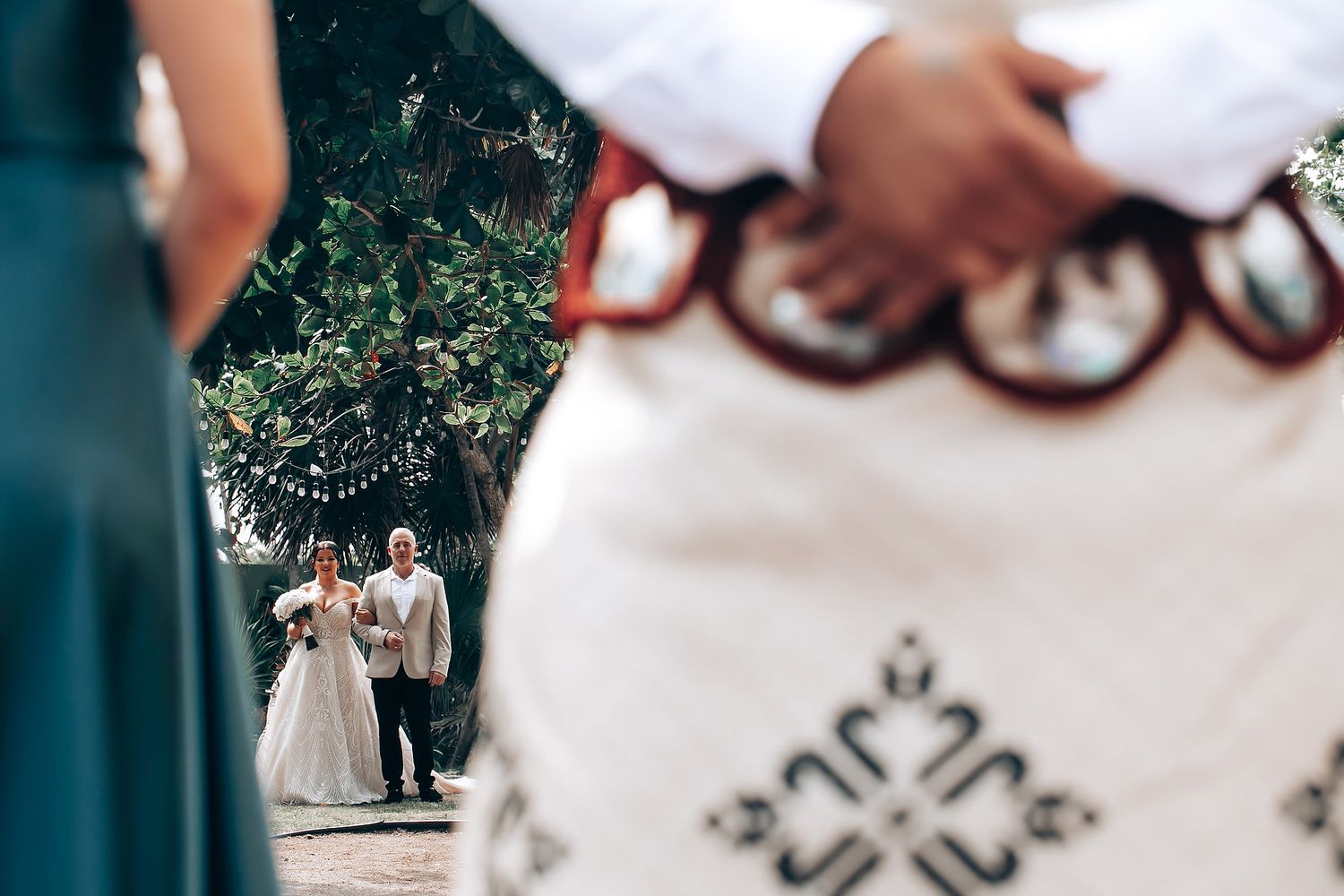 Close-up details of traditional African wedding attire with red and white beaded embellishments.