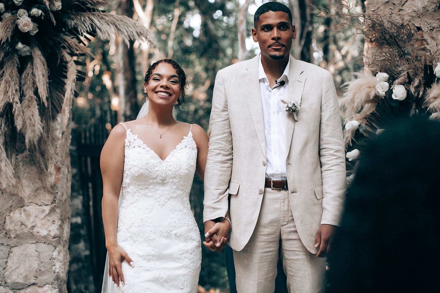 Outdoor wedding ceremony with natural woodland backdrop.