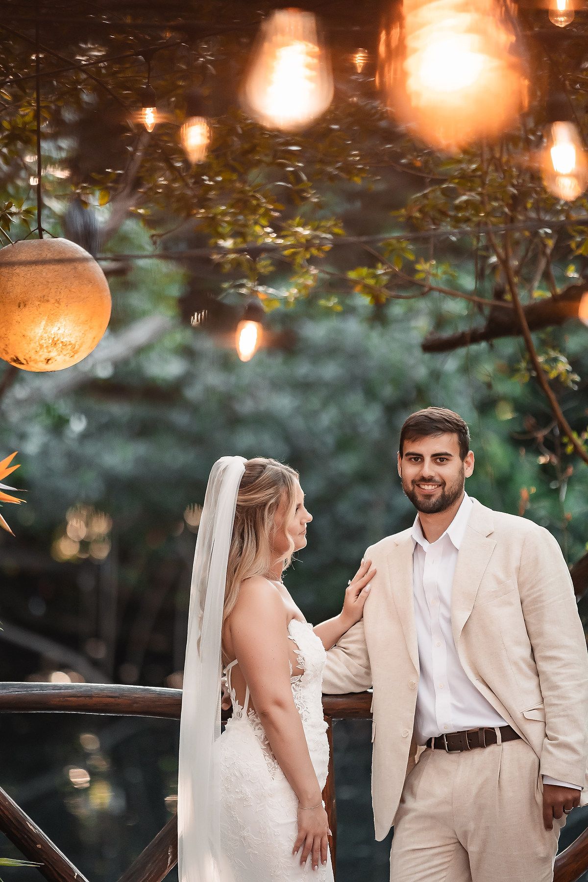 Romantic outdoor wedding scene with glowing lanterns and string lights creating a magical atmosphere.