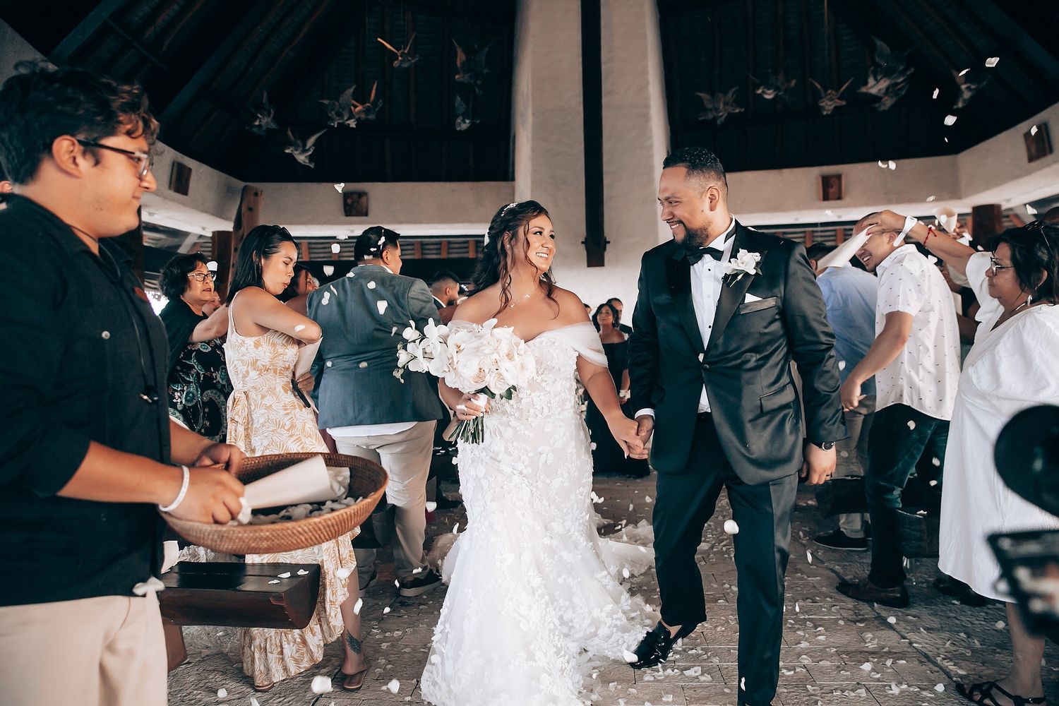 Wedding celebration with guests dancing and confetti flying through the air.