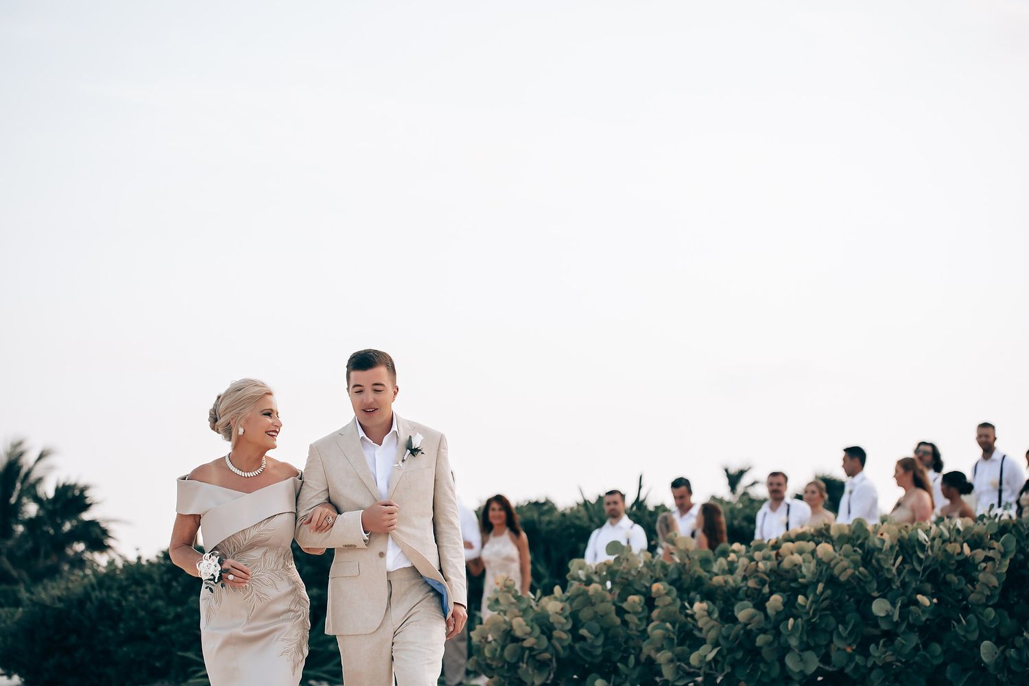 Couple sharing a tender moment during their beach wedding ceremony.