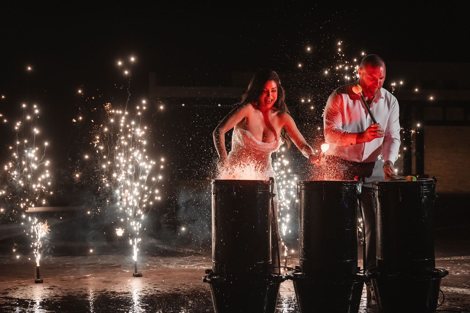 Row of sparklers creating a magical pathway at night during celebration.