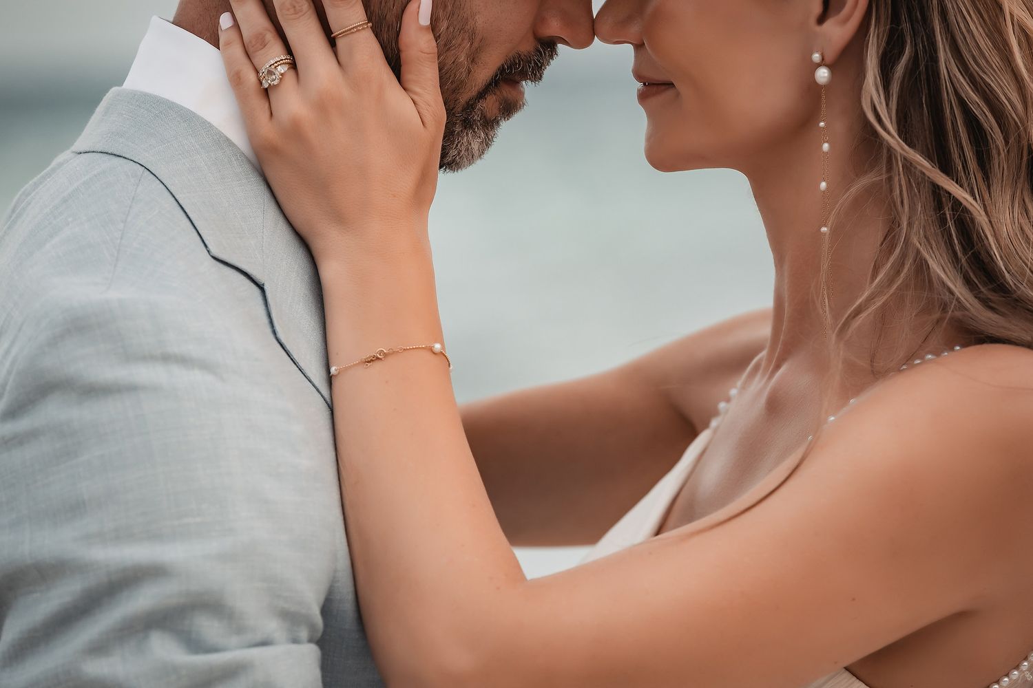 Intimate close-up of a couple sharing a tender moment on the beach.