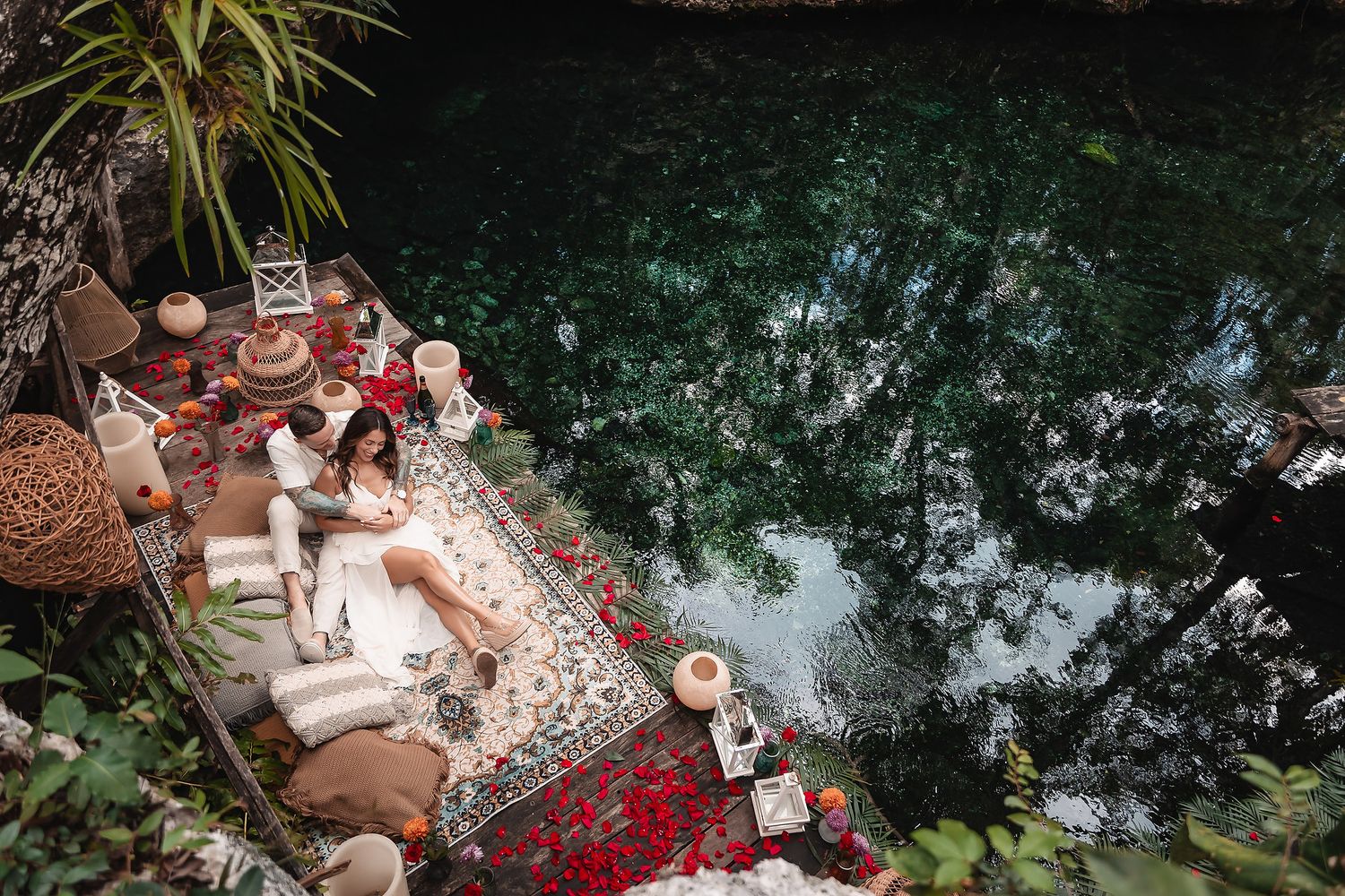 Garden setting with decorative lanterns and scattered rose petals creating a romantic atmosphere.
