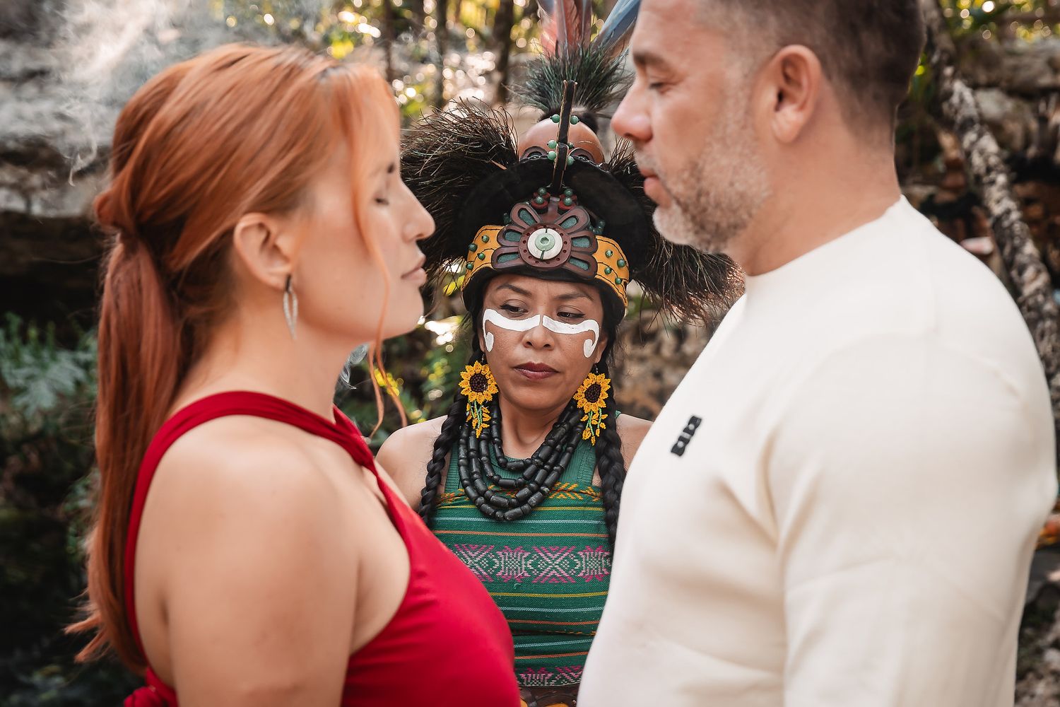 A traditional Mayan ceremony takes place in a natural cave setting.