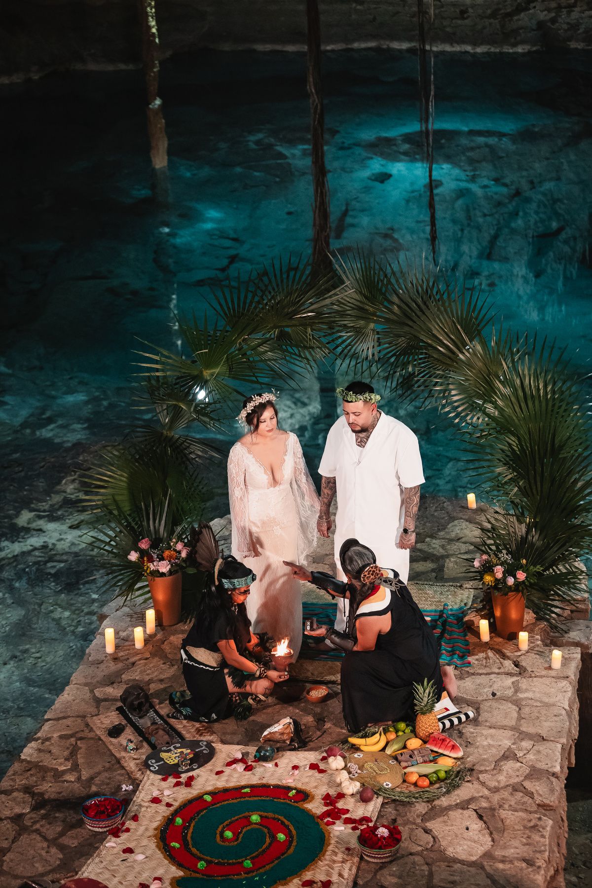 Couple enjoying intimate moment at decorated cave setting with roulette table and candles.